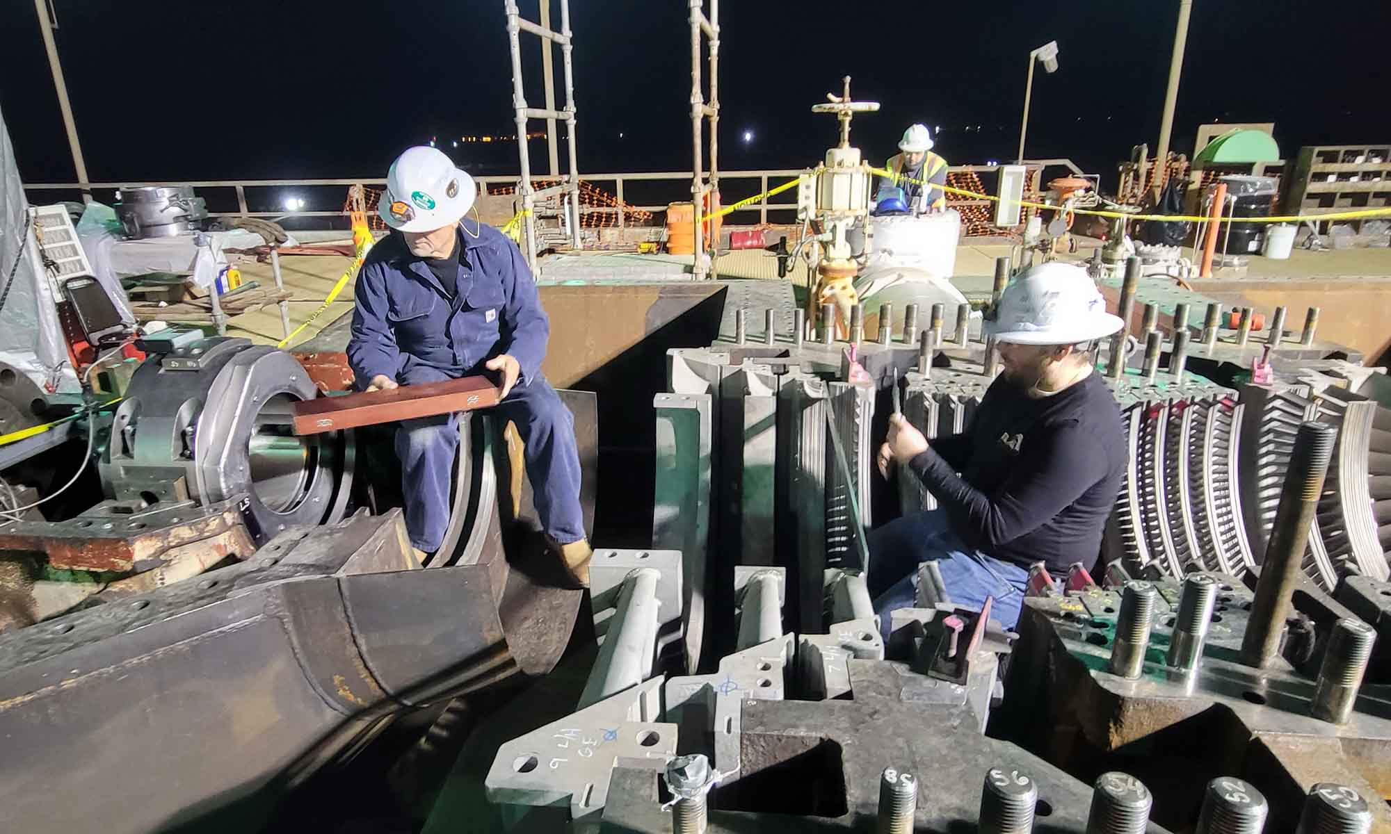 Power plant turbine alignment technician measuring bearings